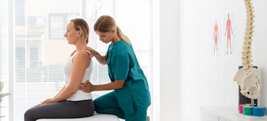 Physiotherapist Helping Patient with Back Problems